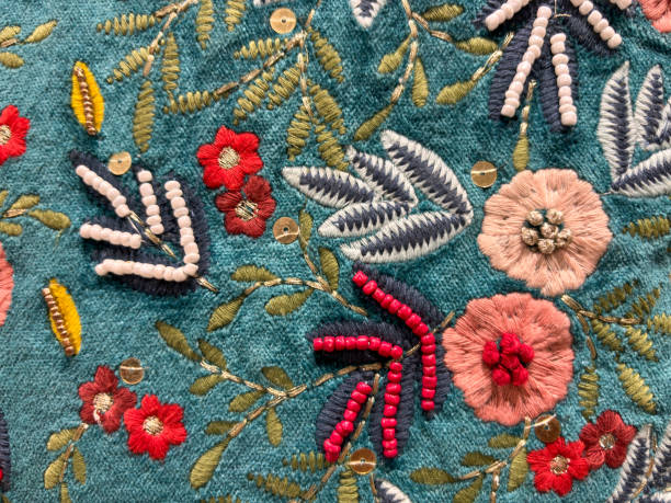 istock A blue and green floral patterned fabric with red flowers embroidered on it 2188458517
