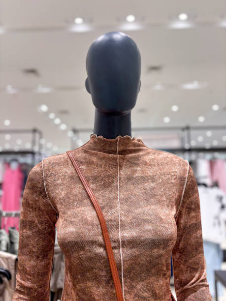 istock A mannequin head wearing a brown dress is displayed in a store 2188458554