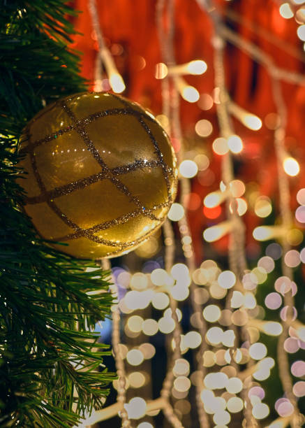 istock Christmas tree decorated with bright  golden decor, bright shining lights on the background 2188464271