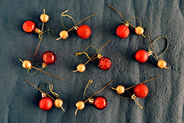 istock Christmas decor with small red balls and golden pins on the textured background, pattern 2188464282