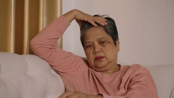 istock Thoughtful Elderly Woman Sitting alone on Sofa in living room 2188467569