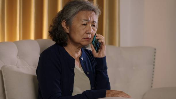 istock Senior Woman Talking on Phone with Concerned Expression 2188467746