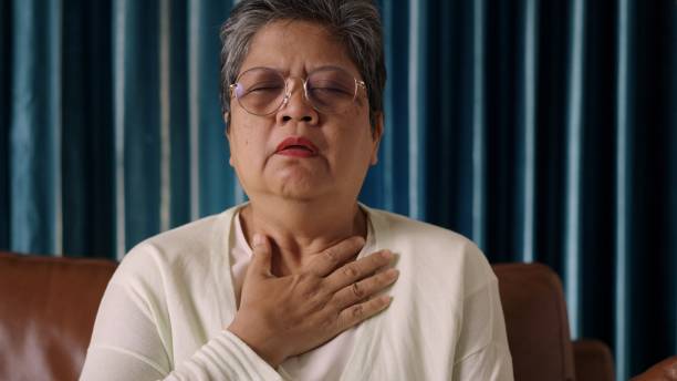 istock Elderly Woman with Hand on Chest while has problem with heart attack 2188467880