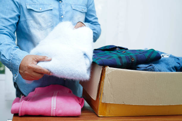 istock Clothes donations in cardboard box for volunteer. 2188468325
