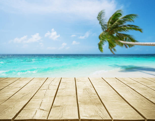 istock Empty wooden table top with tropical paradise beach background 2188475672
