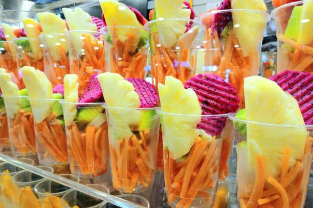 Prepared Fruits in plastic glasses - Smoothie drink preparation.