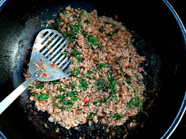 istock Cooking  Stir fried Spicy Pork Basil - Thai food preparation. 2188479662