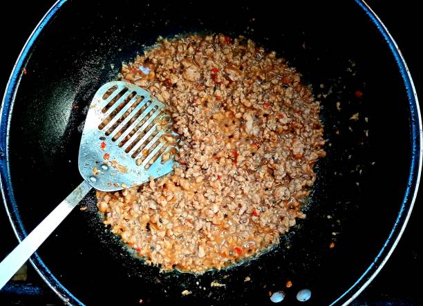 istock Cooking  Stir fried Spicy Pork Basil - Thai food preparation. 2188479664