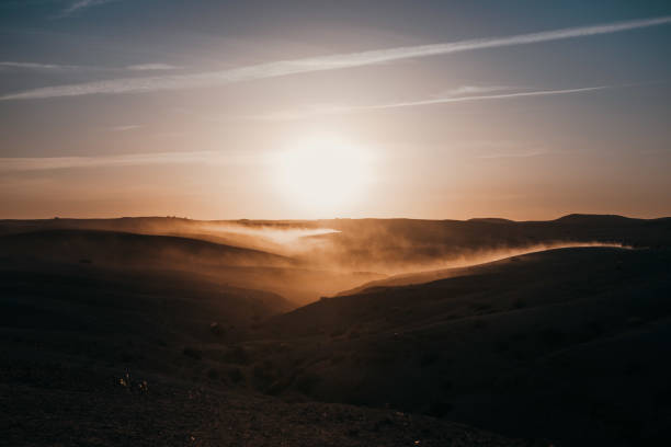 Desert landscape in Morocco during sunset with dust