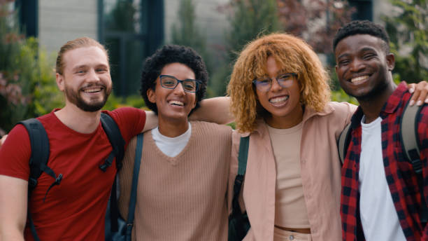 istock Diverse multiethnic multiracial smiling laughing happy talking communicating fun laugh gen z pupils students friends people high school university college academy in city cuddling looking at camera 2188483349