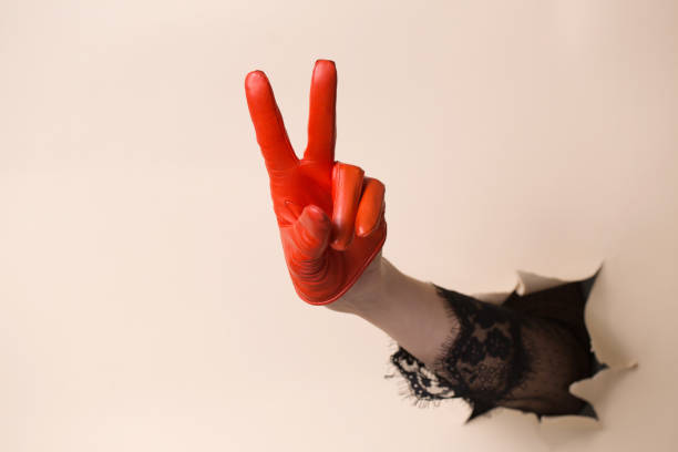 istock A woman's hand in a leather glove shows a gesture victory hand 2188483637