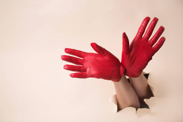 istock Two female hands in red leather gloves with open palms 2188483675