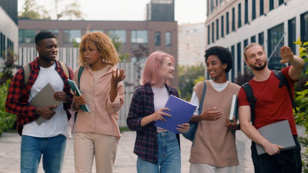 istock Happy multiracial friends diverse classmates multiethnic students smiling talking speaking laughing talk class break walking in city outdoors university college discuss studying education friendship 2188484456