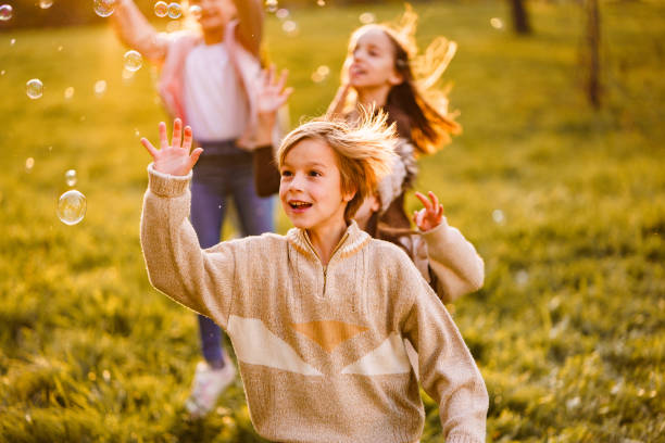 istock Boy and his friends playing whit bubbles 2188484803