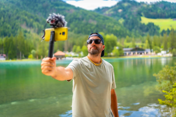 istock Content creator recording a video at lake dobbiaco in the dolomites 2188486950
