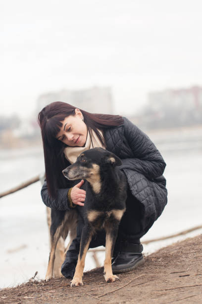 istock A woman plays with her dog on a walk 2188487009