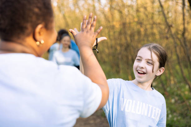 istock Motivated cheerful child sharing high five with her friends 2188487542