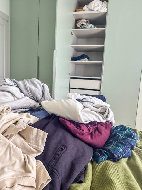 istock Messy Wardrobe and Pile of Clothes on the Bed 2188487761