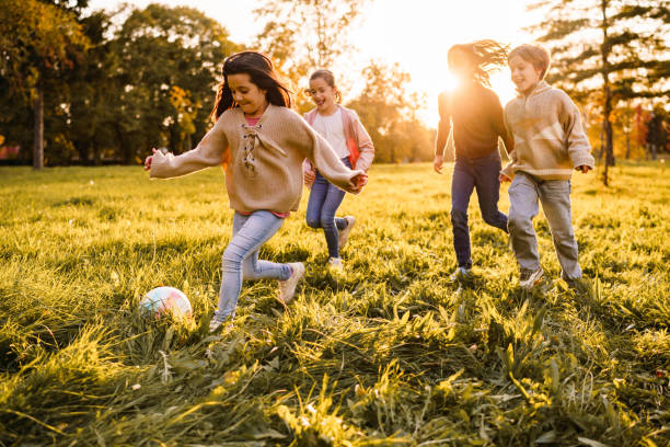 istock Children playing soccer in public park 2188487790