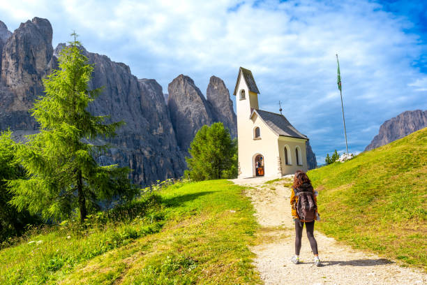 istock Tourist walking towards a chapel on the dolomites 2188487877