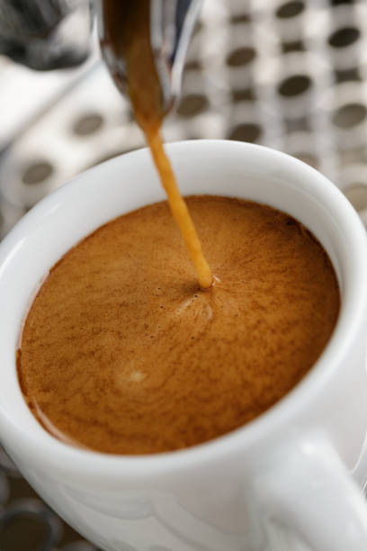 istock espresso pouring from professional coffee machine into white cup 2188489105