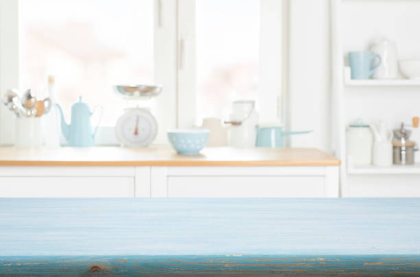 istock Blue kitchen table background on blur abstract furniture and window sill interior 2188490284