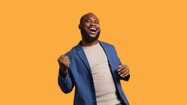 Portrait of joyful man celebrating, studio background