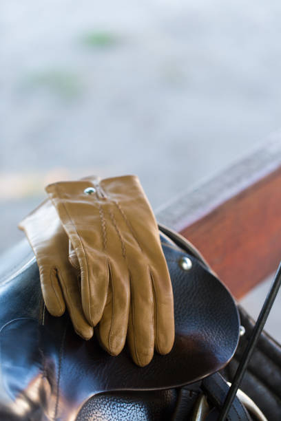 istock Beige leather gloves on a saddle for a horse 2188492862