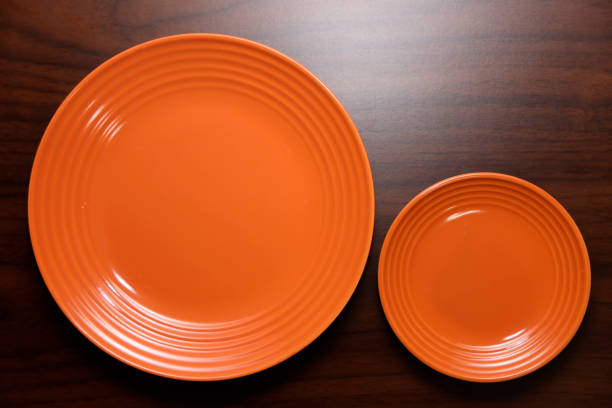 istock Empty orange plate on wooden background. 2188492974