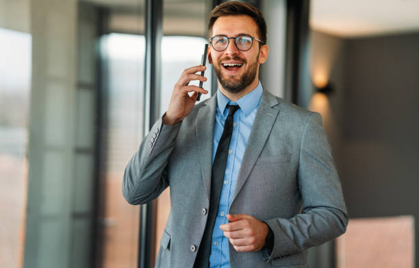 istock Happy middle aged business man executive using mobile cell phone in office. 2188495292