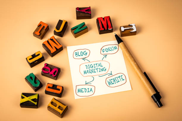 istock Digital Marketing. Notepad and wooden alphabet letters on a light background 2188497014