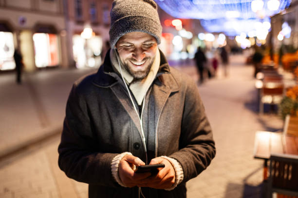 istock Young Man Enjoying Music and Browsing Phone 2188497173