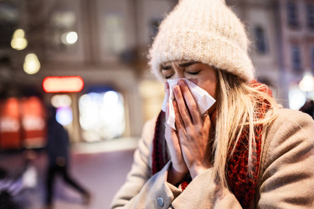 Young Woman Fighting a Cold While Walking Outside