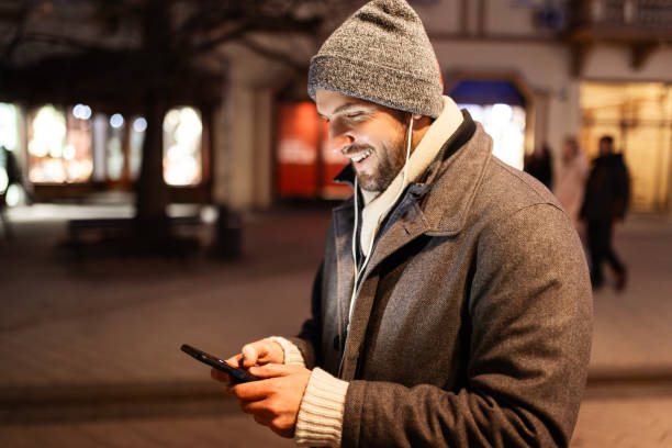 istock Man Unwinding with Smartphone and Headphones 2188497279