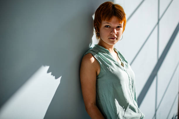 istock Relaxed woman leaning against wall in bright light 2188498150