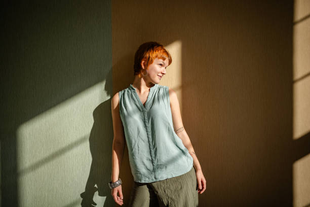 istock Serene woman in gentle sunlight casts soft shadows. 2188498240