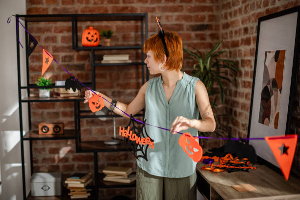 istock Woman decorates for Halloween with festive bunting 2188499049