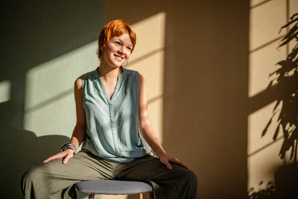 istock Woman in sunlight smiling with soft inviting demeanor. 2188499689