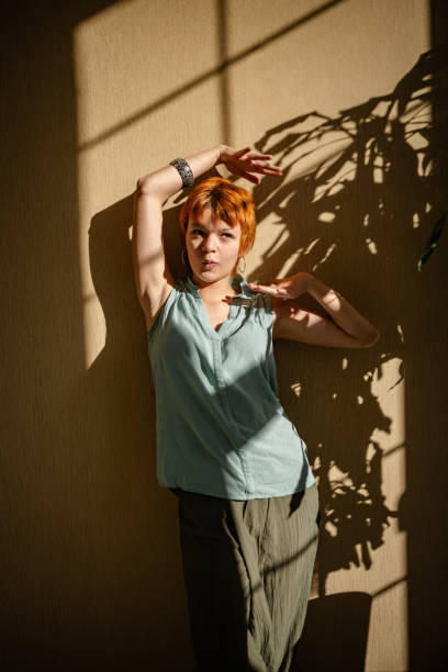 istock Woman posing with artistic shadow background 2188500037