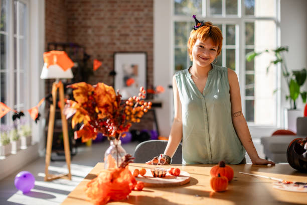 istock Woman smiling while decorating for Halloween 2188501293