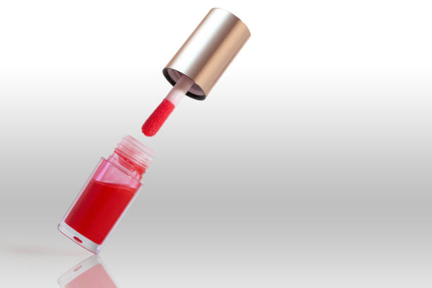 Levitate red lip gloss lipstick in transparent packaging isolated on white background.