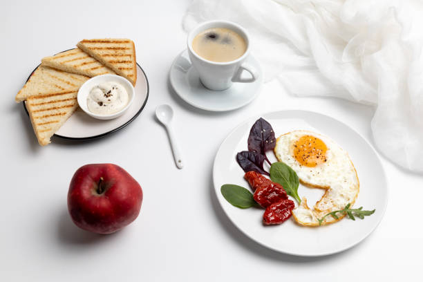 istock Fried egg on the plate, toasts with sauce and a cup of coffee. 2188501824