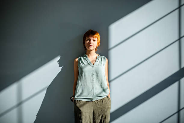 istock Young woman in soft light with shadowed background 2188502014