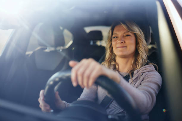istock Smiling woman going on a trip by car. 2188502191