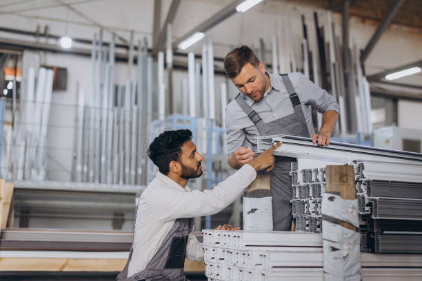 istock Two careful international workmen inspecting windows with shutter at workshop indoor 2188502244