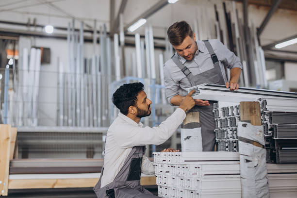 istock Two careful international workmen inspecting windows with shutter at workshop indoor 2188502274