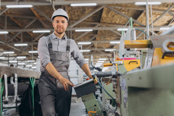 istock Factory male bearded worker is programming a CNC milling machine with copy space. 2188502531