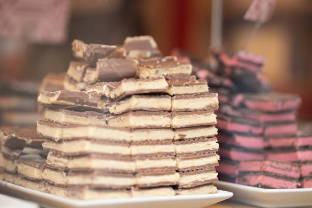 Chocolate with various fillings neatly arranged in a display window. Ideal for food, confectionery, gourmet products, and dessert marketing content.
