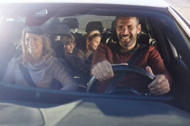 istock Happy family enjoying while going on a road trip by car. 2188502635
