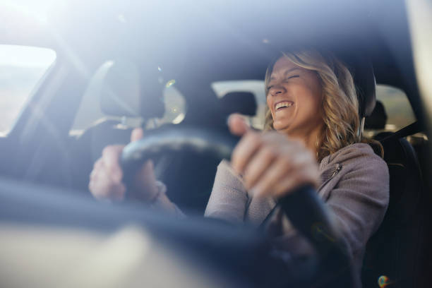 istock Cheerful woman having fun while driving a car. 2188502656